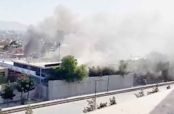Smoke erupts from Sikh temple after attack by the IS.