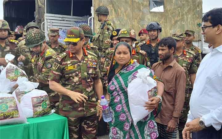 Chief of Army Staff General SM Shafiuddin Ahmed distributes relief materials among flood-affected people at Companyganj in Sylhet on Sunday.