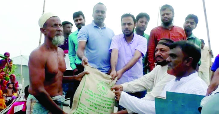 KURIGRAM: Officials of District Administration give relief goods among the flooded people in Porarchar at Jatrapur Union on Sunday.