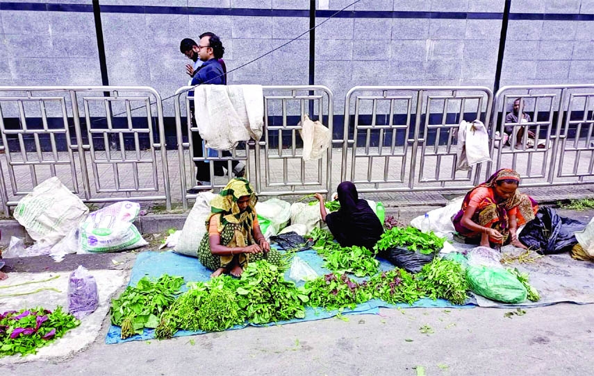 Women sell various types of vegetables in front of Bangladesh Bank on Monday to maintain their livelihood.