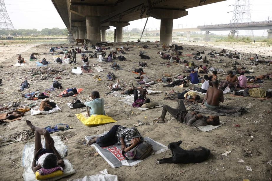 Homeless people sleep in the shade of an overbridge on a hot day in New Delhi, Friday, May 20, 2022. The Indian capital and surrounding areas are facing extreme heat wave conditions.