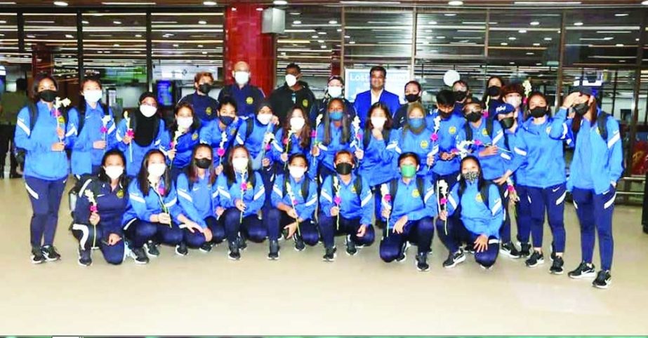 Members of Malaysia Women's Football team with the officials of Bangladesh Football Federation pose for a photo session at the Hazrat Shahjalal International Airport in the city on Monday night. Agency photo