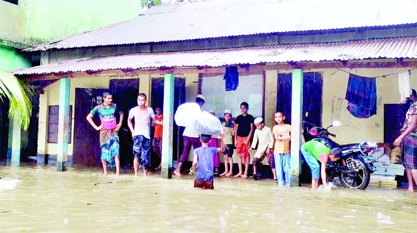 NETRAKONA: The main road of Kalmakanda Upazila Sadar goes under flood water due to incessant rainfall . The snap was taken on Tuesday.