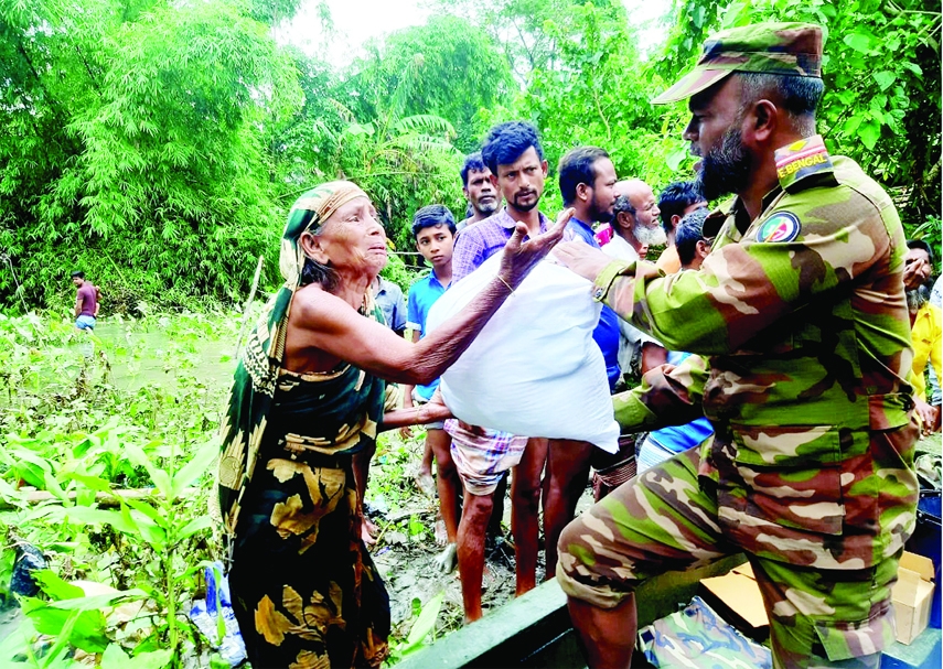 SYLHET: Army officials distribute relief among the flood hits in Sylhet on Wednesday.