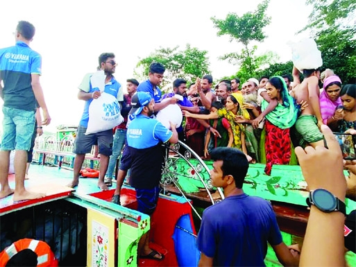 SUNAMGANJ : Relief distributes among the flood hits at Sunamganj organised by Yamaha Riders Club on Thursday.