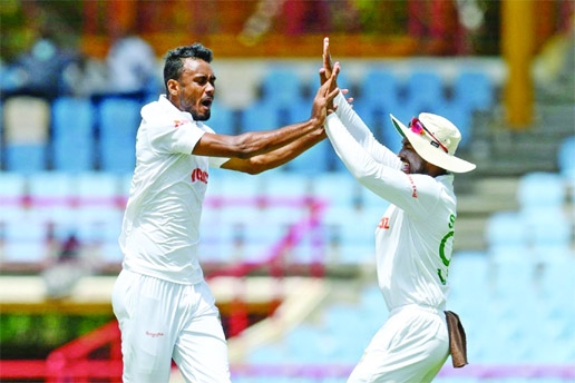 Shoriful Islam (left) celebrates with Najmul Hossain Shanto after taking a wicket against West Indies during the 2nd Test of Day 2 at Darren Sammy Cricket Ground, Gros Islet, Saint Lucia on Saturday.
