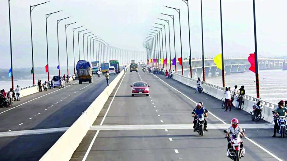 Vehicles ply on the Padma Bridge after it opened to traffic on Sunday. NN photo