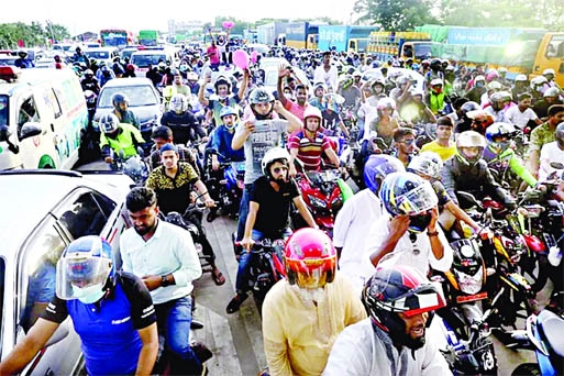 Hundreds of motorcyclists gather at the toll plaza on the Mawa end of the Padma Bridge as it opened to traffic on Sunday.