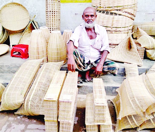 A man is seen sitting in front of fishing instruments at Tulshighat in Sadar upazila under Gaibandha district on Monday for sale.