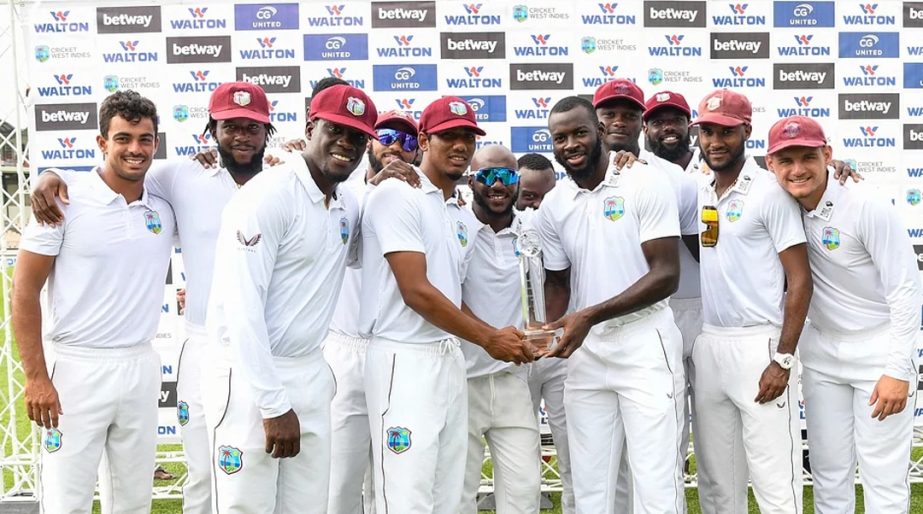 Members of the West Indies team stand for a photo with the trophy after winning on the fourth day of the 2nd Test between Bangladesh and West Indies at Darren Sammy Cricket Ground in Gros Islet, Saint Lucia on Monday. Agency photo