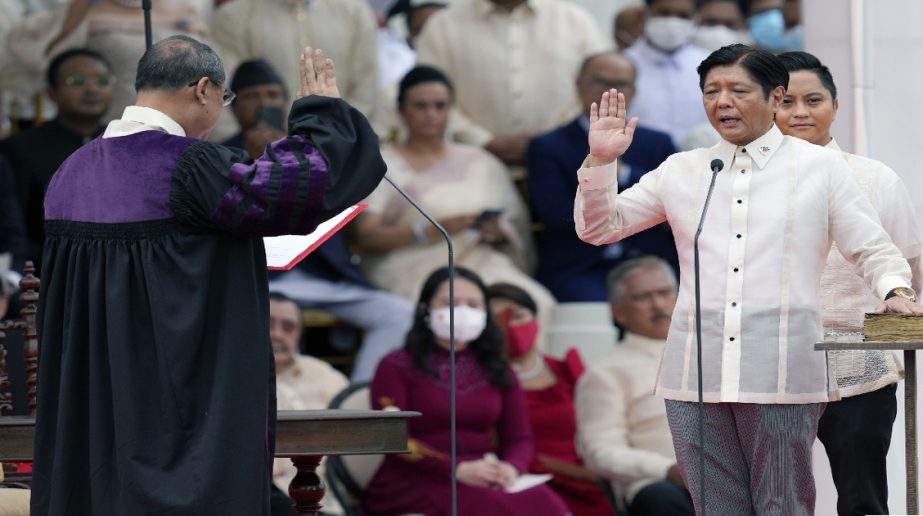 President-elect Ferdinand "Bongbong" Marcos Jr., right, is sworn in by Supreme Court Chief Justice Alexander Gesmundo during the inauguration ceremony at National Museum on Thursday, June 30, 2022 in Manila, Philippines.