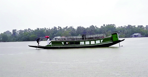 People move by boat from a flood-affected area to a safe place in Sunamganj on Thursday as flood situation in the district worsened following last two days’ heavy rainfall.