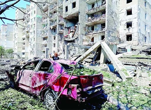 A car is partially buried under rubble against the back-drop of a destroyed apartment building in the Ukrainian city of Odesa after Russia's latest airstrike on civilians on Friday.