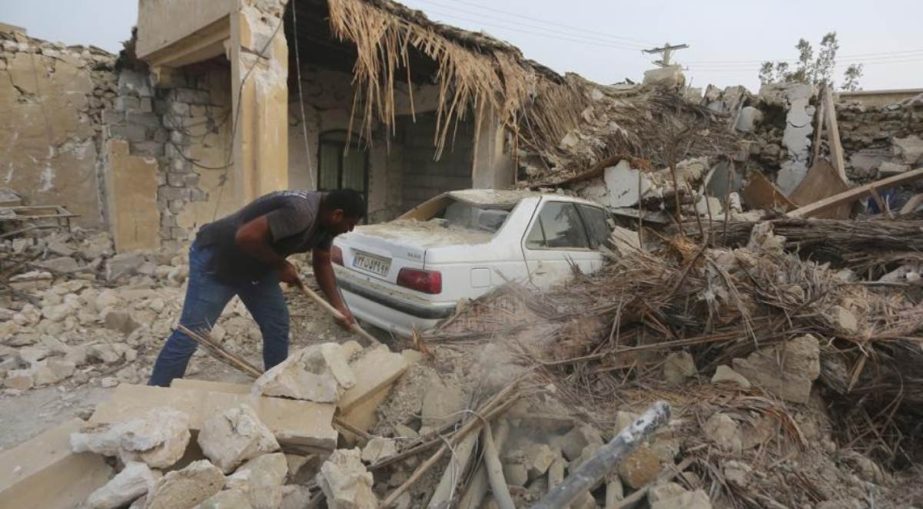 A man cleans up the rubble after an earthquake at Sayeh Khosh village in Hormozgan province, some 620 miles (1,000 kilometers) south of the capital, Tehran, Iran, Saturday, July 2, 2022.