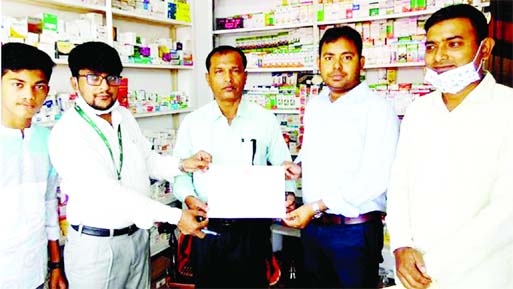 GABTOLI (Bogura): Md Shariful Islam, Assistant Director of Bogura Drug Administration gives certificate to A B M Abu Sayed, Proprietor of JS Medicine Corner in Gabtoli Upazila on Saturday.