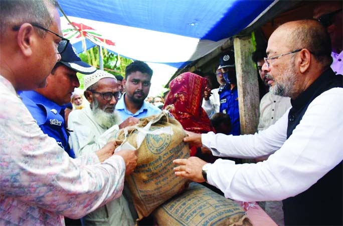 SYLHET : State Minister of Disaster Management and Relief Dr. Md. Enamur Rahman distributes relief among the flooded people at Dharmopasha Upazila in Sunamganj on Saturday.