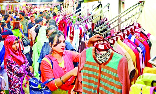 Customers observe dresses in city's Basundhara city shopping complex on Wednesday for upcoming Eid-ul-Azha.