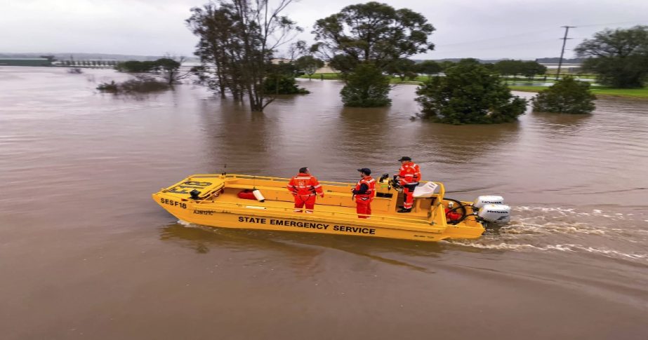 In this photo provided by the State Emergency Service, a boat patrols the Hunter River near Hinton, Australia, Wednesday, July 6, 2022.