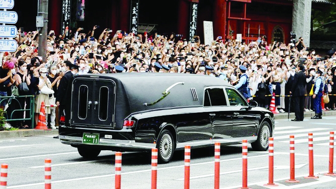 A vehicle carrying the body of the late former Japanese Prime Minister Shinzo Abe, who was shot while campaigning for a parliamentary election, leaves after his funeral at Zojoji Temple in Tokyo, Japan on Tuesday.