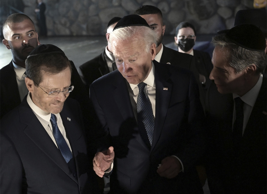 President Joe Biden, center, speaks with U.S. Secretary of State Antony Blinken, right, and Israel's President Isaac Herzog at the Hall of Remembrance of the Yad Vashem Holocaust Memorial Museum in Jerusalem, Wednesday, July 13, 2022.
