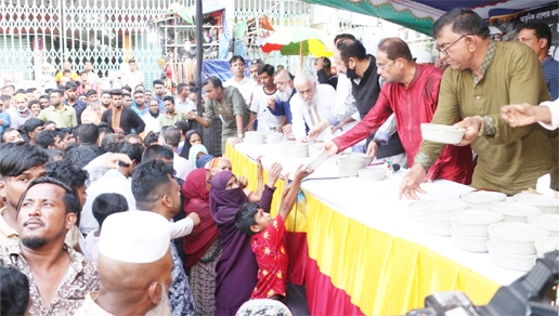 Jatiya Party Chairman GM Kader, MP distributing food among the destitute at Jurain Railgate in the city's Shyampur on Friday at a memorial meeting of Pallibandhu Hussian Muhammad Ershad.