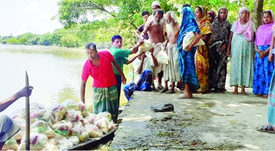 Education Secretary of Dharmapasha Upazila Awami League Md Suhebur Rahman Suheb distributes Eid gifts among the flood-victims of Sunamganj's Dharmapasha Upazila on Friday.