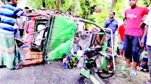 Onlookers stand in front of a maimed auto rickshaw after being collided head-on with a bus in Bakergonj area on Barishal-Patuakhali Highway on Wednesday leaving five people dead.