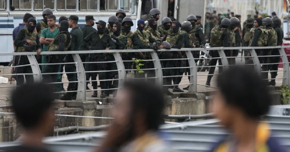 Army soldiers stand guard near a barricade following an eviction of protesters from the presidential secretariat premise in Colombo, Sri Lanka, Friday, July 22, 2022.