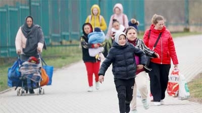 Ukrainian refugees walk after crossing the Ukraine-Poland border, amid the Russian invasion of Ukraine, in Medyka near Przemysl, Poland.
