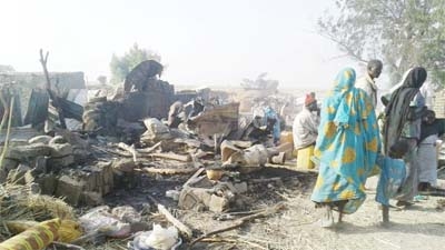 Corpses are wrapped with clothes after bomb explosion in Nigeria's Borno state.