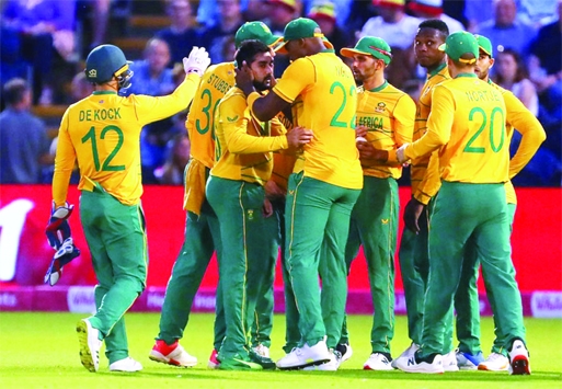 South Africa's Tabraiz Shamsi (centre) is congratulated by teammates after the dismissal of England's Sam Curran (not in the picture) during their second Twenty20 International match at Cardiff in England on Thursday.