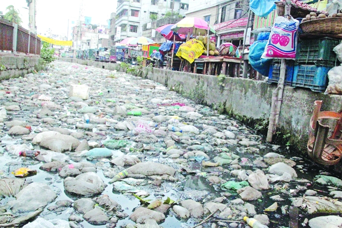 A canal is in a sorry state in city's Dolairpar area, as some unconscious local people dumped garbage into it despite having dustbin there. This photo was taken on Friday.