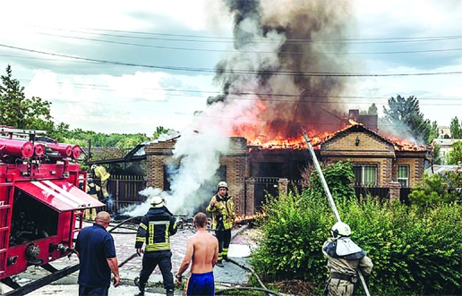 Firefighters extinguish a fire in a shelled house after a Russian military strike in Bakhmut, Ukraine on Friday.