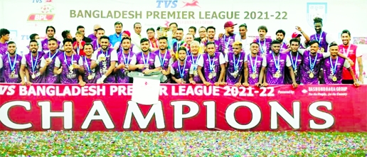 Members of Bashundhara Kings and officials of Bangladesh Football Federation pose for a photo session with the championship trophy of the TVS Bangladesh Premier League Football at Bashundhara Sports Complex in Dhaka on Saturday.