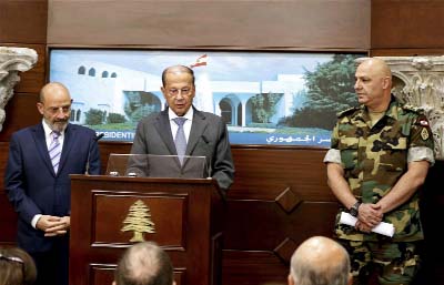 Lebanese Army Commander Gen. Joseph Aoun, (right), and Spanish Defense Minister Yacoub Sarraf, (left), listen to Lebanese President Michel Aoun, speaking to journalists at the Presidential Palace in Baabda, east of Beirut, Lebanon