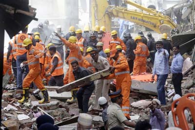 Rescue workers clear debris from the site of a building collapse in Mumbai on Thursday