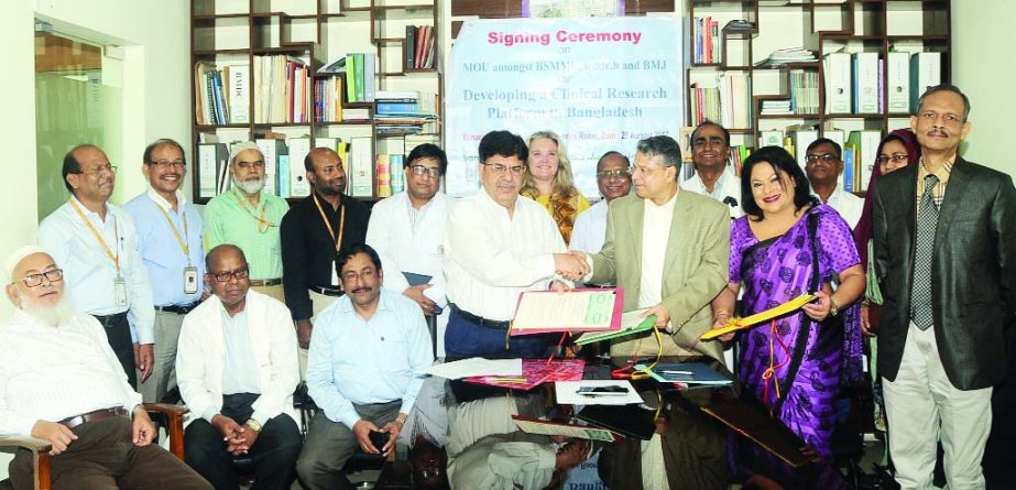 Prof Kamrul Khan, Vice Chancellor of Bangabandhu Sheikh Mujib Medical University, Prof John D Clemens, Executive Director of icddr,b and Prashant Mishra, Managing Director-India of the British Medical Journal exchanging documents of a MoU signed among the