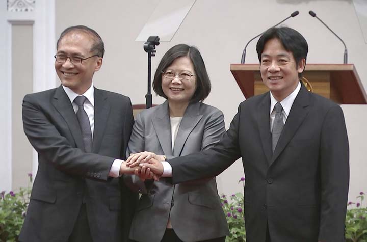 Taiwan's President Tsai Ing-wen, (centre), holds hands of the outgoing premier Lin Chuan, left, and incoming premier William Lai on Tuesday in Taipei.