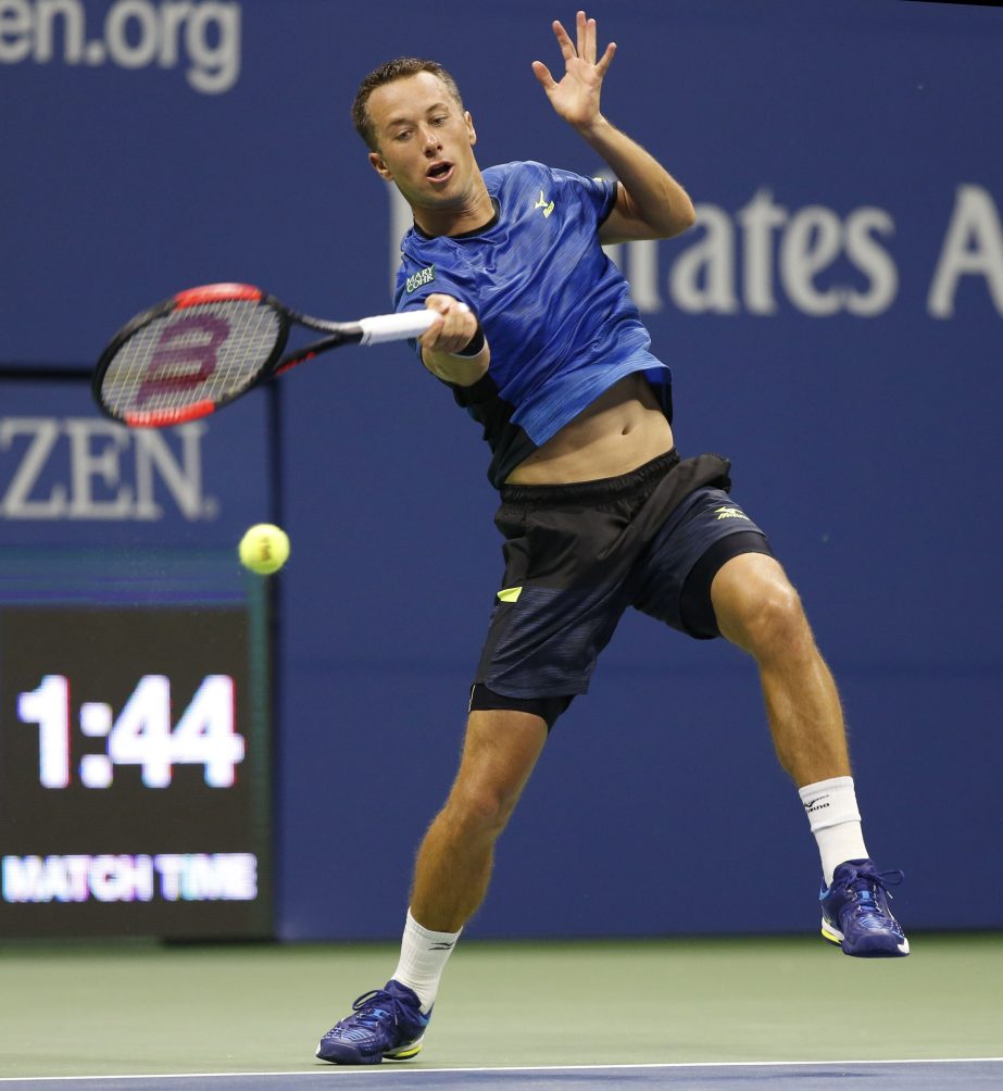Philipp Kohlschreiber of Germany, returns in a fourth-round match against Roger Federer of Switzerland, at the US Open tennis tournament in New York on Monday. Federer ousted Kohlschreiber from the tournament.
