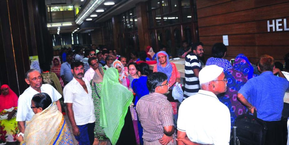 People interested in savings crowd for submitting the form of three-year family savings project despite the AC is out of order. This photo taken at Bangladesh Bank on Wednesday after noon.