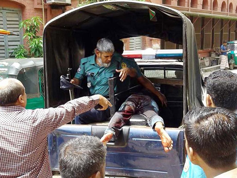 Police taking the injured accused of drug case who was stabbed at the Chittagong Court Building premises on Tuesday.