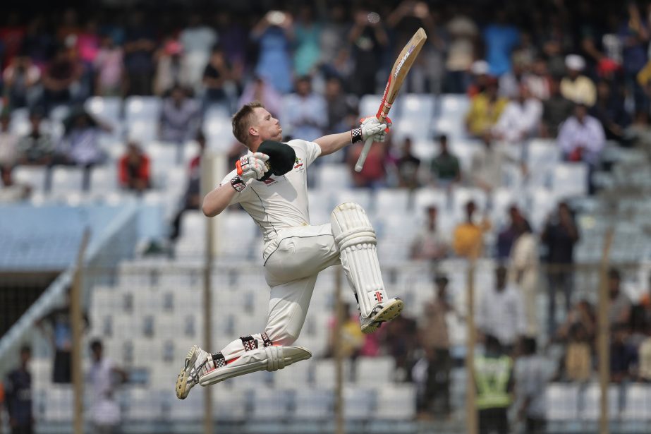 Australia's David Warner jumps in the air in celebration after scoring hundred runs on the third day of the second Test match between Bangladesh and Austrillia at Zahur Ahmed Chowdhury Stadium in Chittagong on Wednesday.
