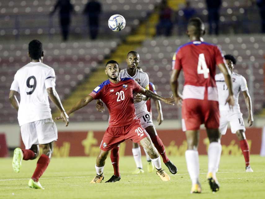 Panama's Anibal Godoy (center) controls the ball under pressure from Trinidad and Tobago's Kevan George, behind, during a 2018 Russia World Cup qualifying soccer match in Panama City on Tuesday.