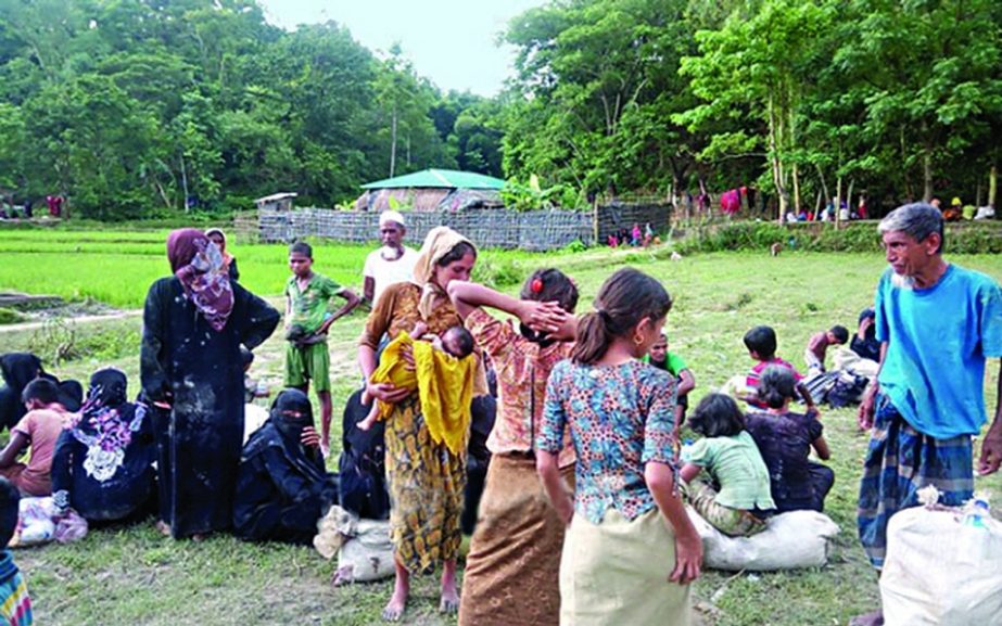 Rohingyas taking shelter at fields available near the Bangladesh-Myanmar border on Wednesday.