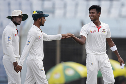 Mustafizur Rahman (right) celebrates with his teammate Nasir Hossain ( center) after the dismissal of Australia's Nathan Lyon during the fourth day of the second Test cricket match at the Zahur Ahmed Chowdhury Stadium in Chittagong on Thursday.