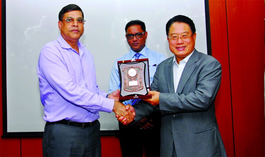 Major General Mohd Habibur Rahman Khan, Executive Chairman of Bangladesh Export Processing Zones Authority, handing over a crest to Li Yong, Director General of United Nations Industrial Development Organization during his visit in Dhaka Export Processing