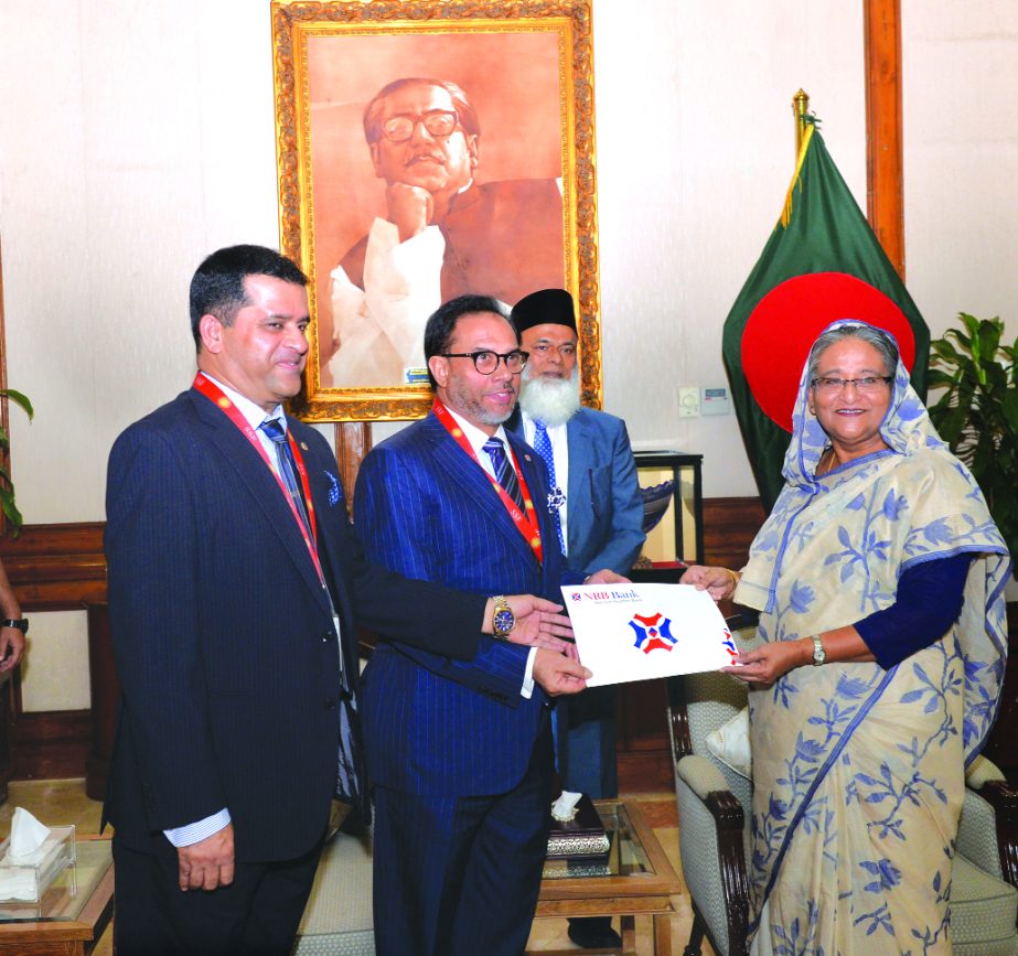 Mohammed Mahtabur Rahman, Chairman of NRB Bank Limited, handing over a cheque of Tk 50 lakh to Prime Minister Sheikh Hasina at Ganobhabon on Sunday for Prime Minister's Relief Fund. Tateyama Kabir, Vice-Chairman of the bank was also present.