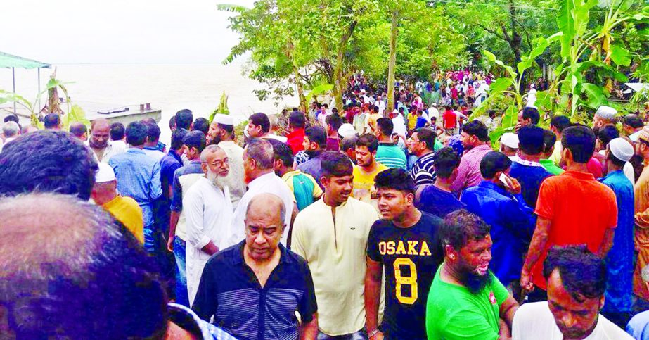 Local people and relatives gathered on the riverbank as 25 people went missing after three launches sank in the Padma at Chairman Ghat in Naria Upazila in Sharitpur district on Monday.