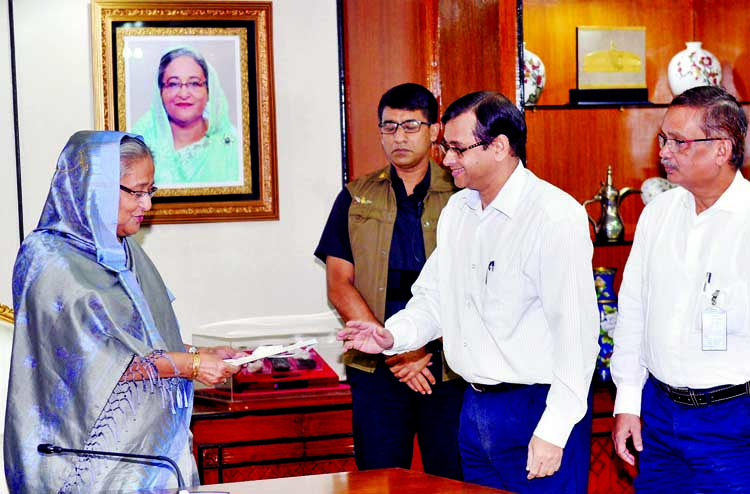Prime Minister Sheikh Hasina receiving cheques from different ministries and institutions for PM's Relief Fund at her office on Monday.