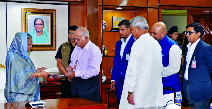 Chairman of Confidence Group Engineer Rezaul Karim and former Chairman Shamsul Alam, Bir Uttam, handing over a cheque to Prime Minister Sheikh Hasina for the rehabilitation of flood-affected people at the latter's office on Monday. Among others, Group Ma